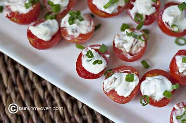 An appetizer tray full of blt stuffed tomatoes