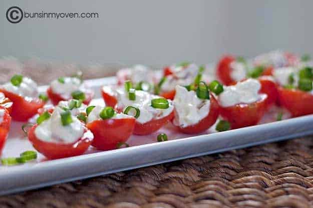 BLT filling in a bunch of tomatoes on an appetizer tray.
