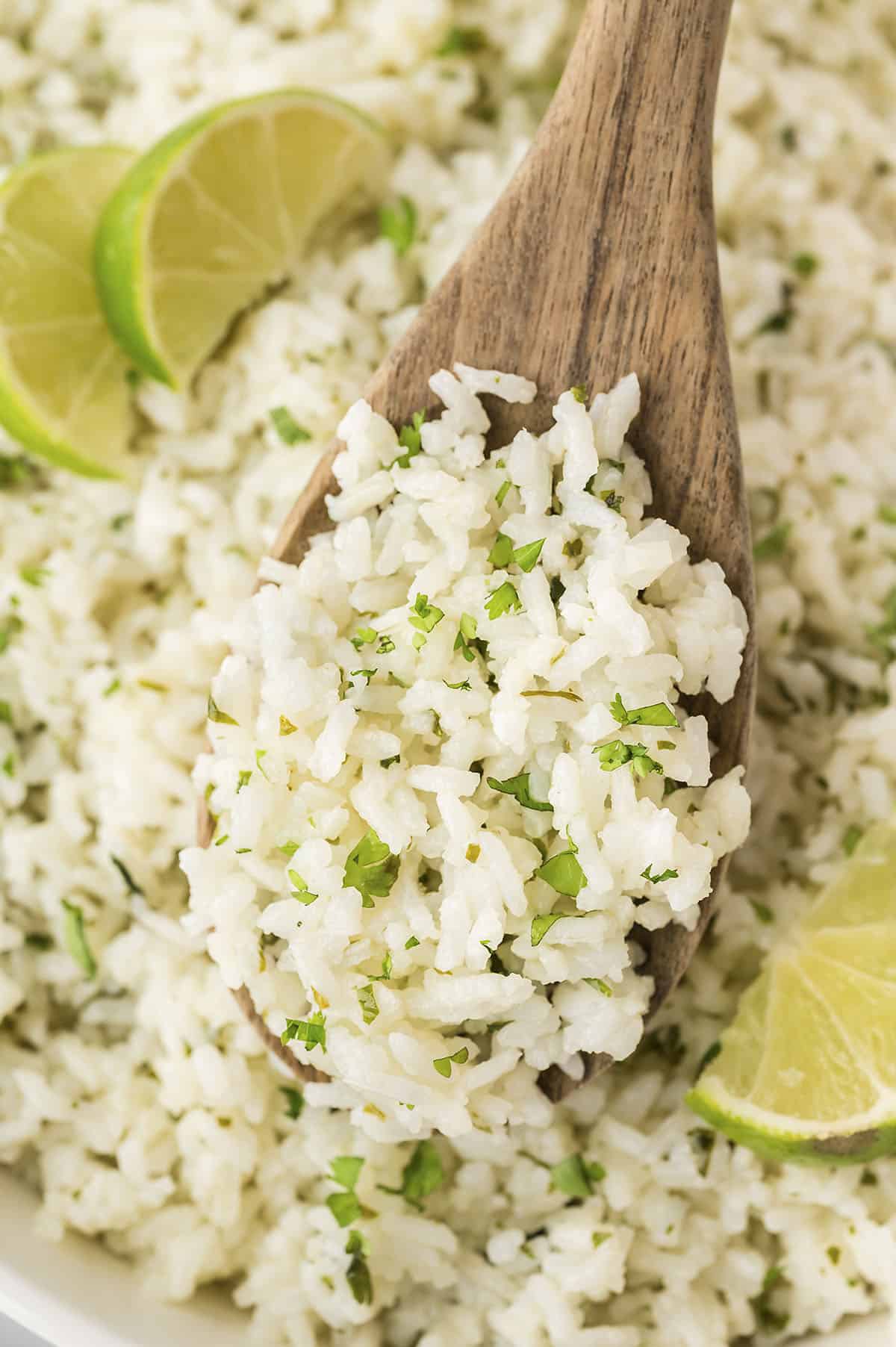 Cilantro lime rice recipe on wooden spoon.