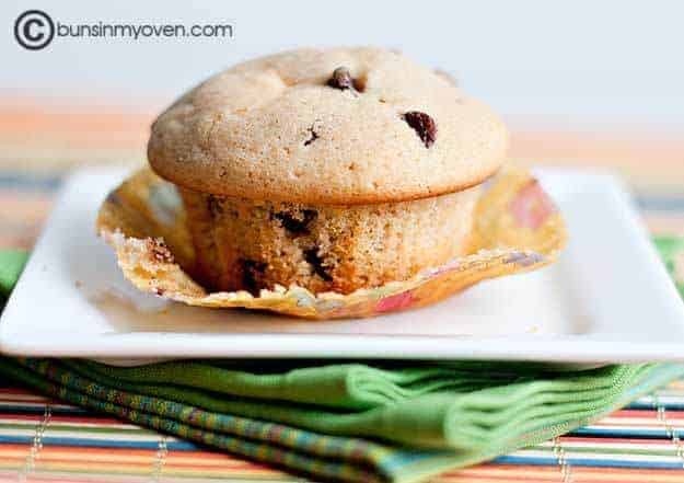 A close up of an unwrapped chocolate chip muffin.