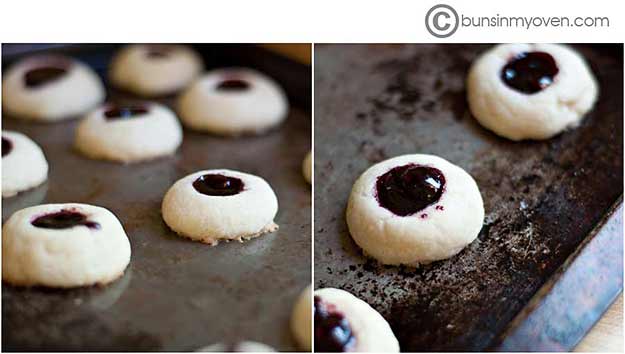 A close up of raspberry thumbprint cookies.
