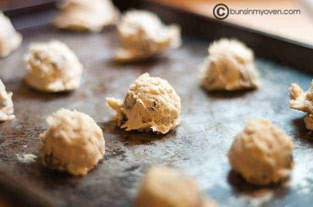 Balls of cookie doughs spread out on a baking sheet 