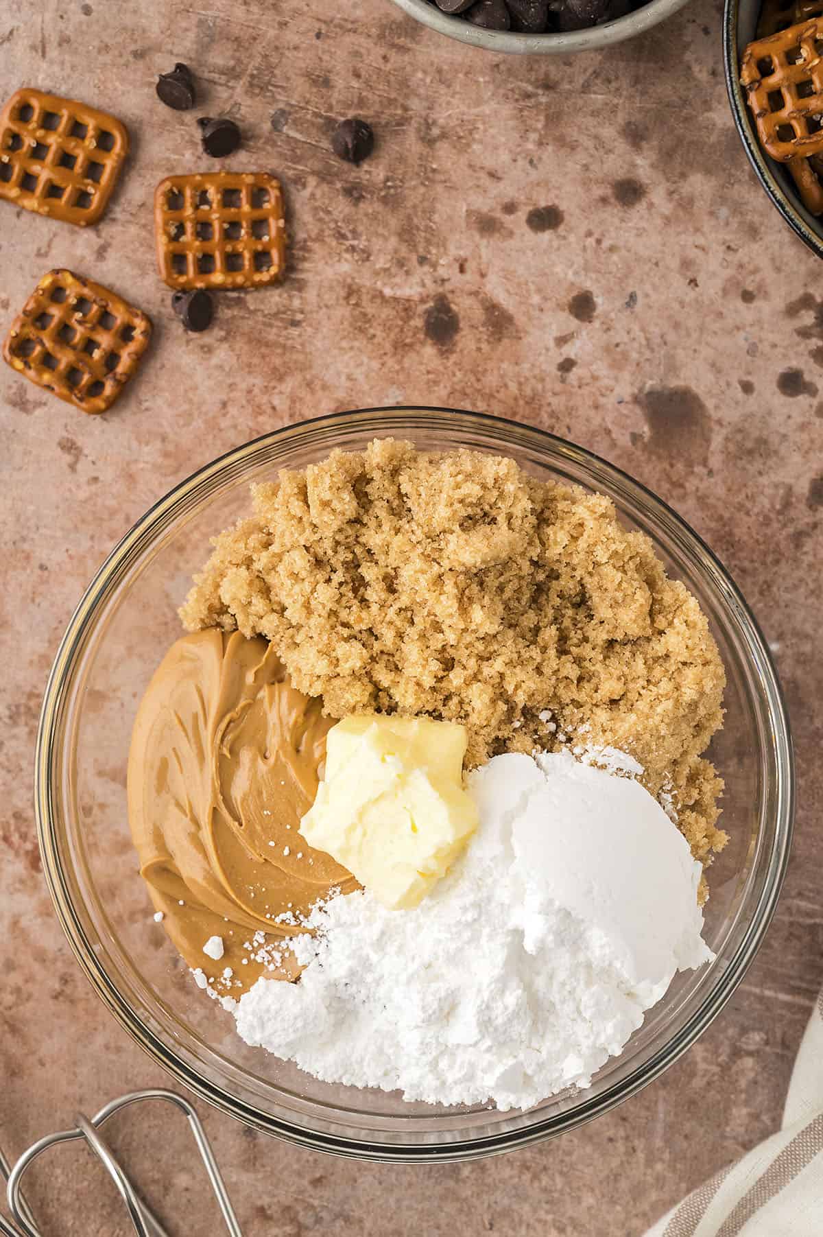 Ingredients for peanut butter balls in mixing bowl.
