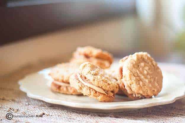 Several peanut butter sandwich cookies on a plate.