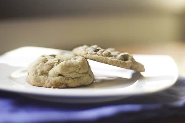 A puffy chocolate chip cookie next to a normal chocolate chip cookie.