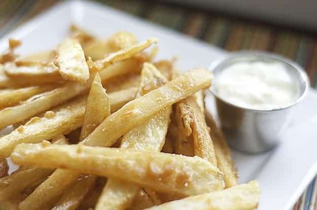 A closeup of battered French fries on a plate 