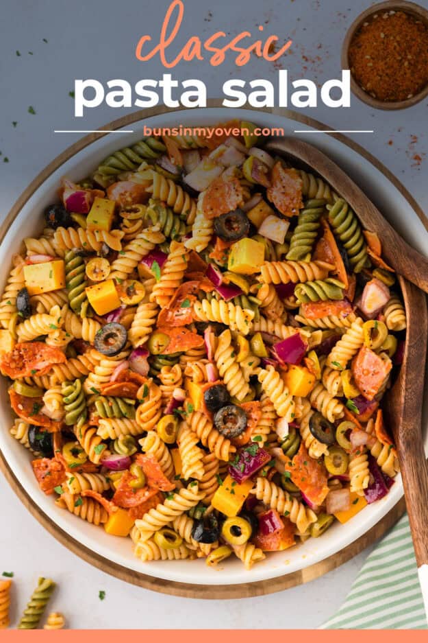 Overhead view of pasta salad in mixing bowl with text for Pinterest.