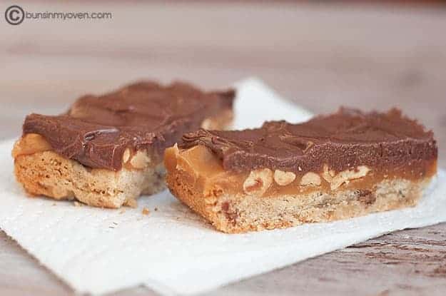 A piece of square peanut butter bars topped with chocolate frosting.