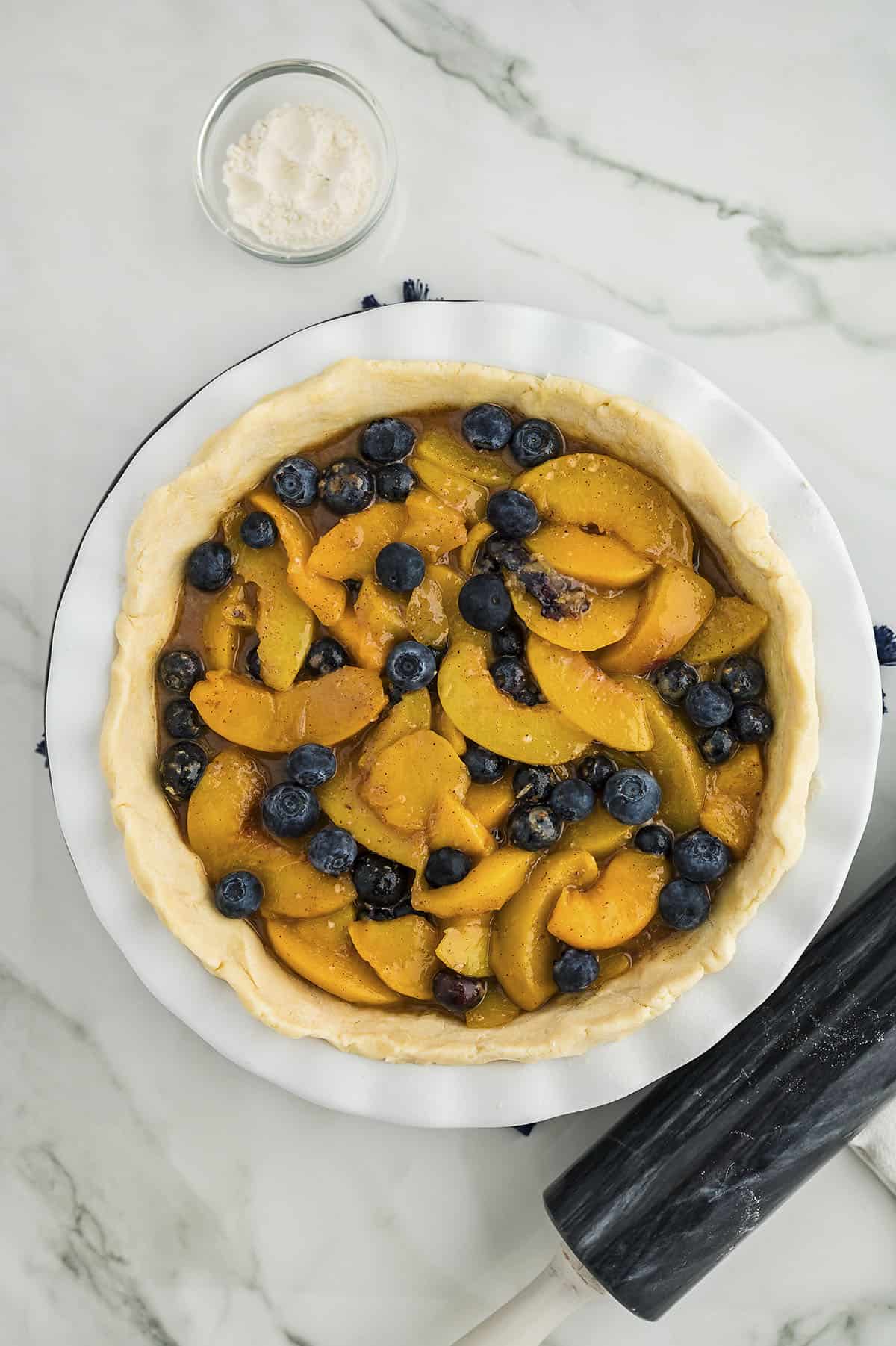 Peach blueberry pie filling in crust.