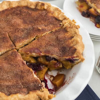 Blueberry peach pie with cinnamon sugar topping on crust.