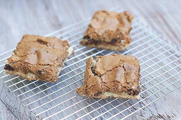 Three hot fudge peanut butter bars on a cooling rack 