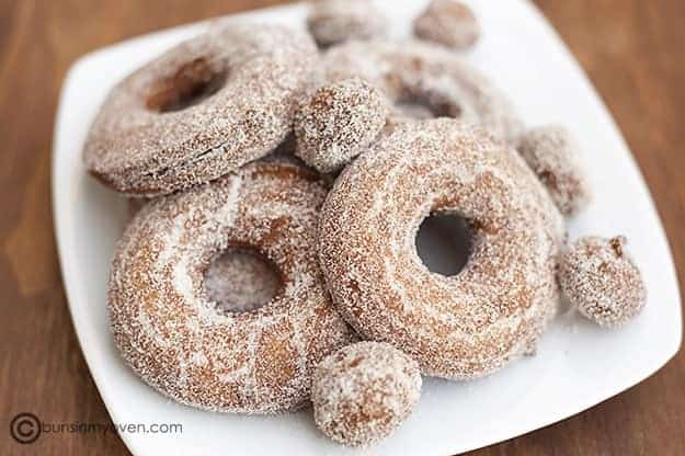Apple cider donut recipe fried up and on a white plate.