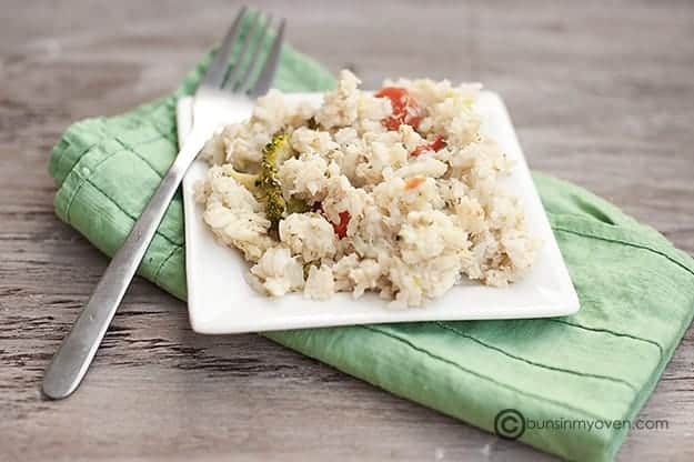 A small square plate of chicken and rice.