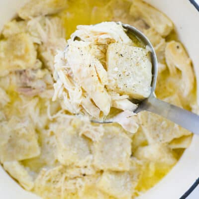 chicken and dumplings in white dutch oven.