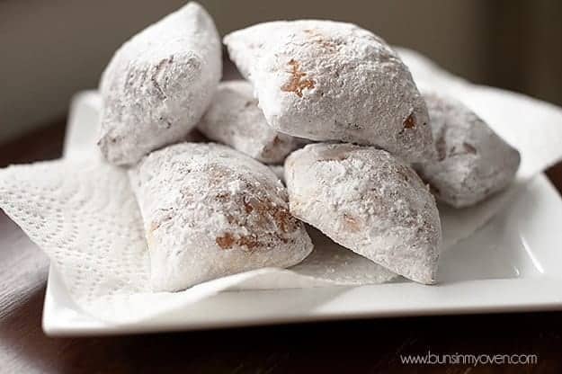 Six Beignets on a white square dish.