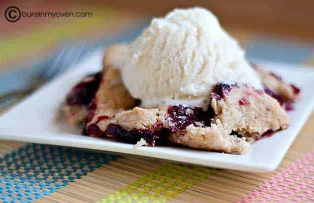 Ice cream on top of a serving of blackberry cobbler.