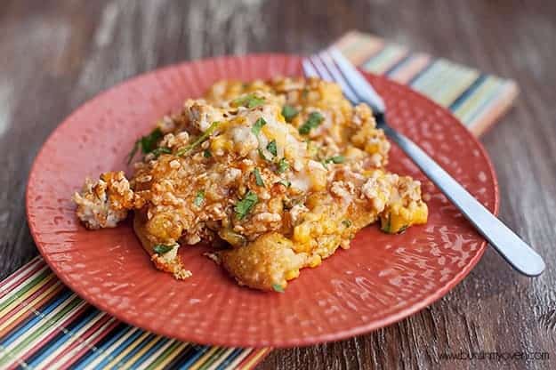 Chicken tamale casserole served on a small red plate