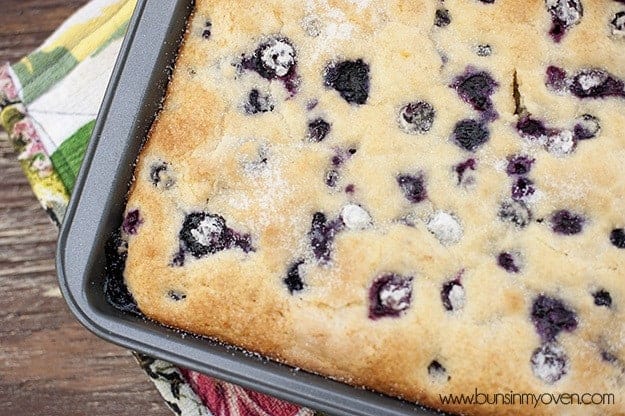 An overhead view of buttermilk blueberry cake on a baking sheet
