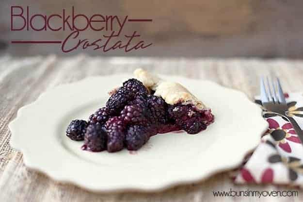 A serving of blackberry Crostata on a white plate 