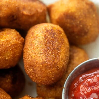 Homemade corn dog bites in basket.