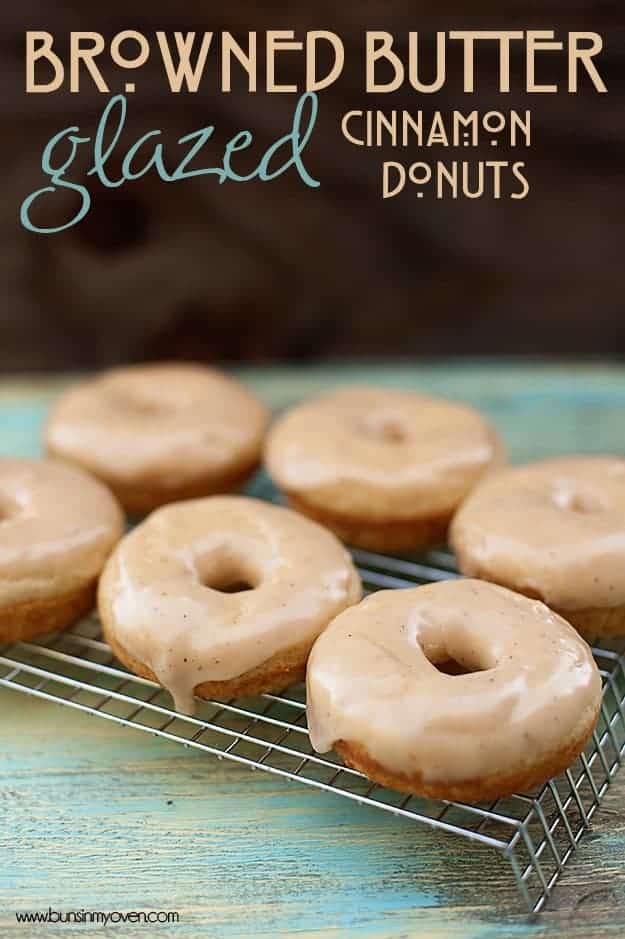 Six brown butter glazed cinnamon donuts on a cooling rack.