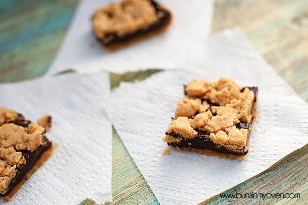 Three chocolate peanut butter bars on a table