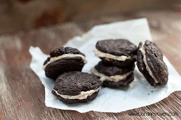 Several homemade buttercream sandwich cookies on a table