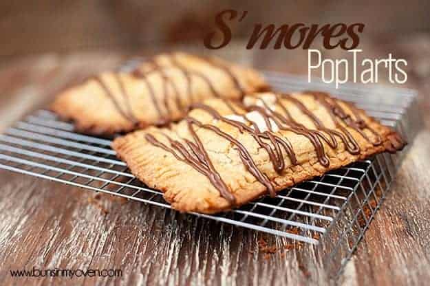 Two smores pop tarts resing on a wire cooling rack.