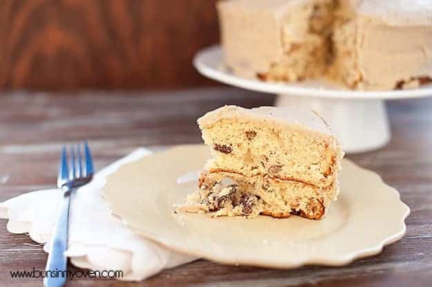 A triangle piece of pecan cake on a decorative cake plate.