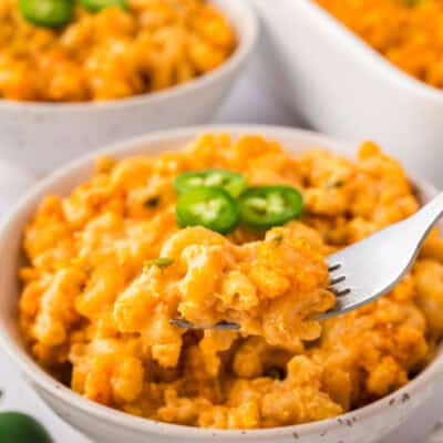 Forkful of jalapeno mac and cheese in bowl.