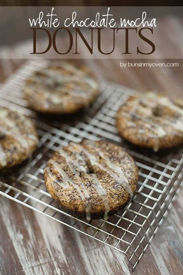 White chocolate frosted mocha donuts on a wire cooling rack