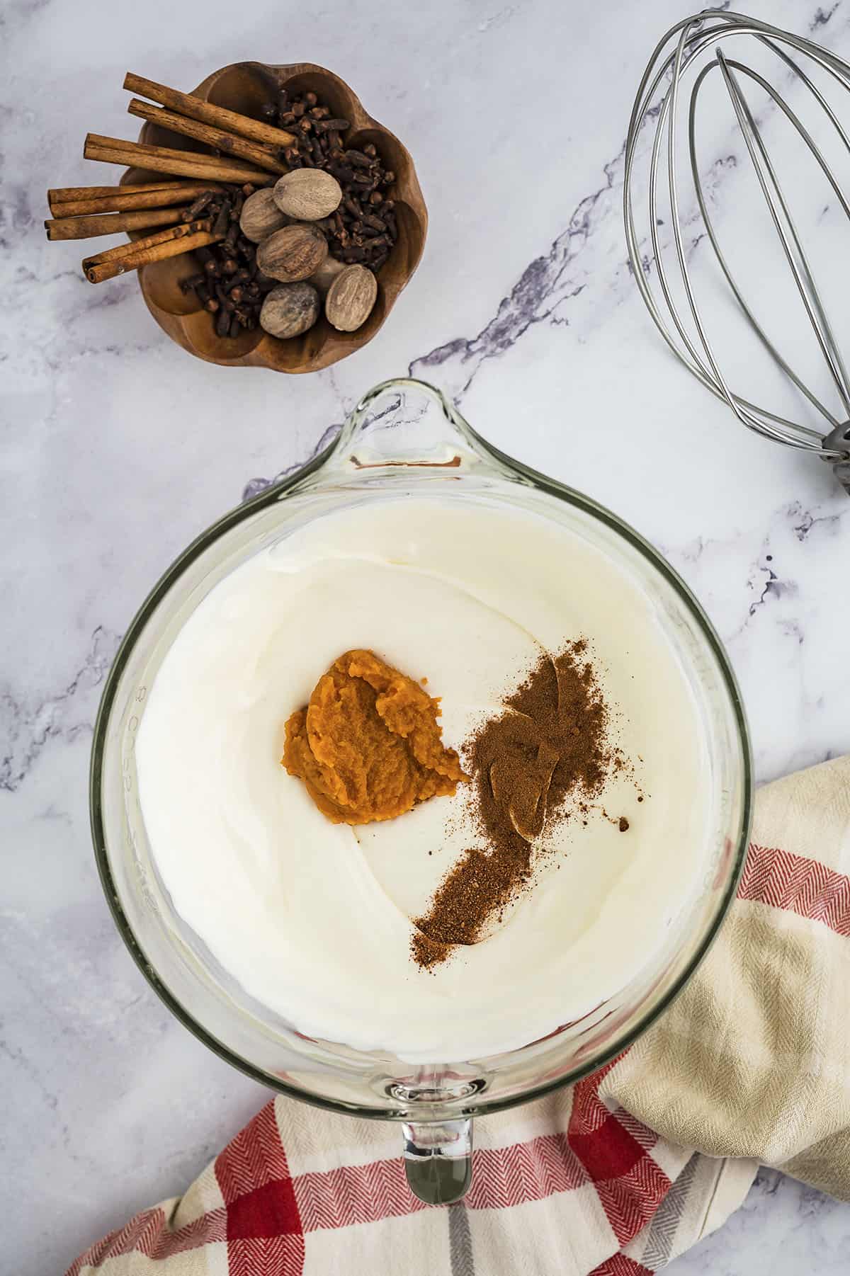 Pumpkin, spices, and condensed milk added to whipped cream.