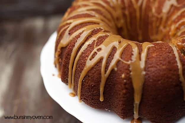 Apple pound cake on a  cake stand topped with apple cider glaze