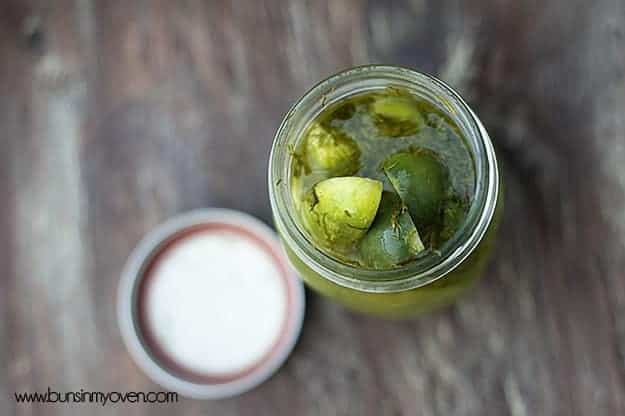 A close up of pickle spears in a glass jar.