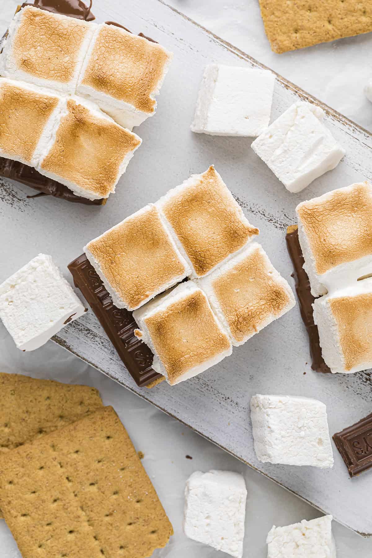 Toasted marshmallows on graham crackers with chocolate.