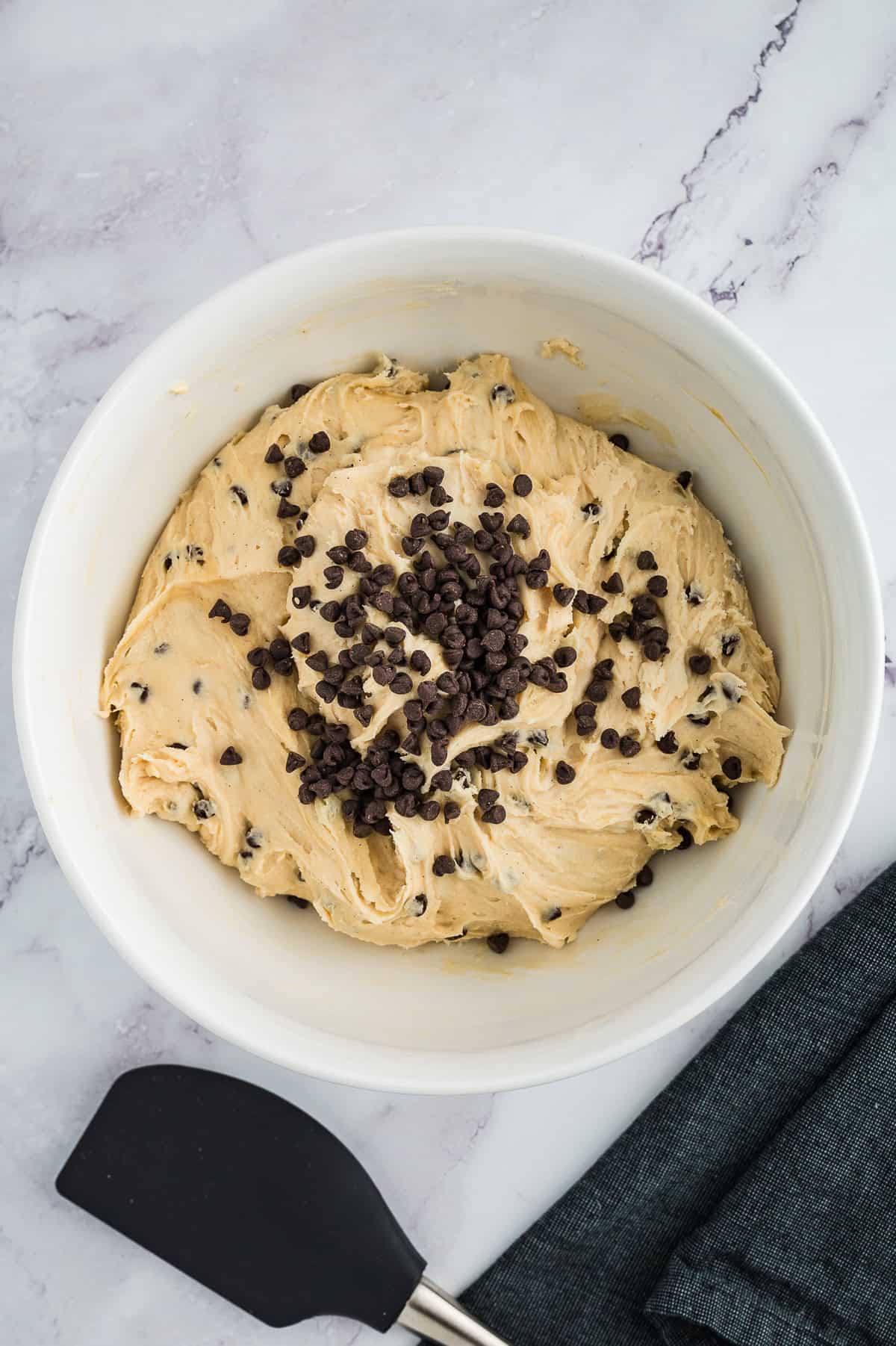 Cookie dough fudge being mixed together in bowl.