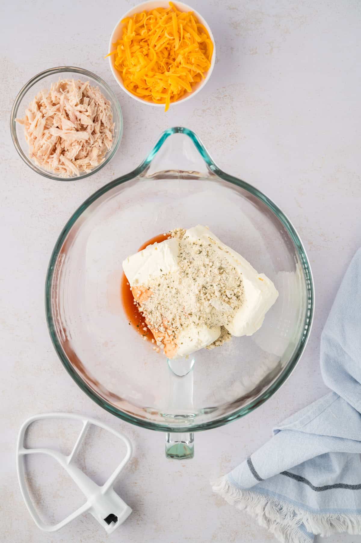 Ingredients for buffalo chicken cheese ball in mixing bowl.