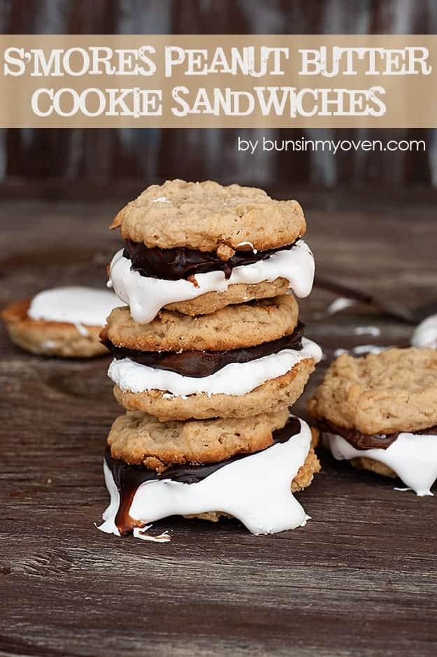 Three stacked up smores cookie sandwiches on a table.