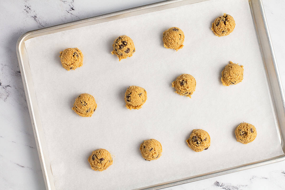 Cookie dough balls on cookie sheet.