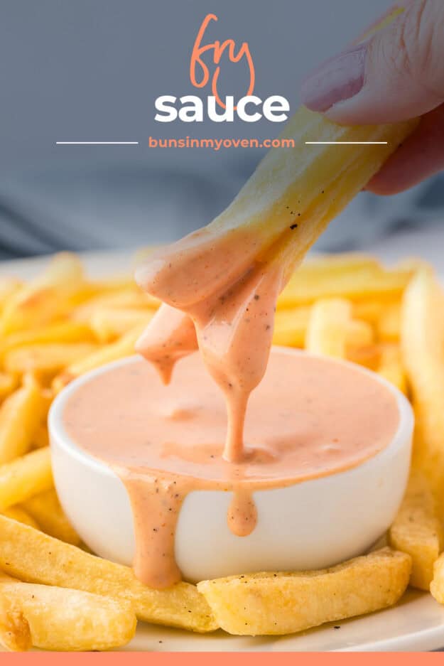 Fries being dipped in fry sauce.