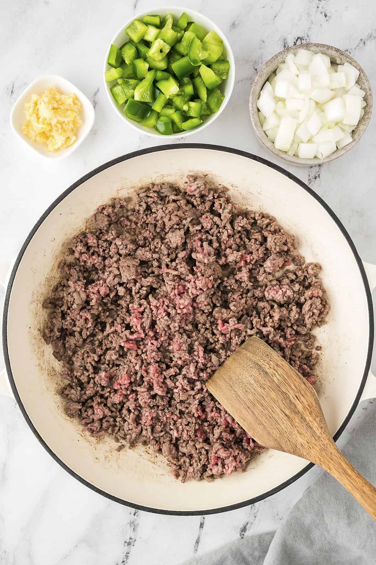 Ground beef being browned in skillet.