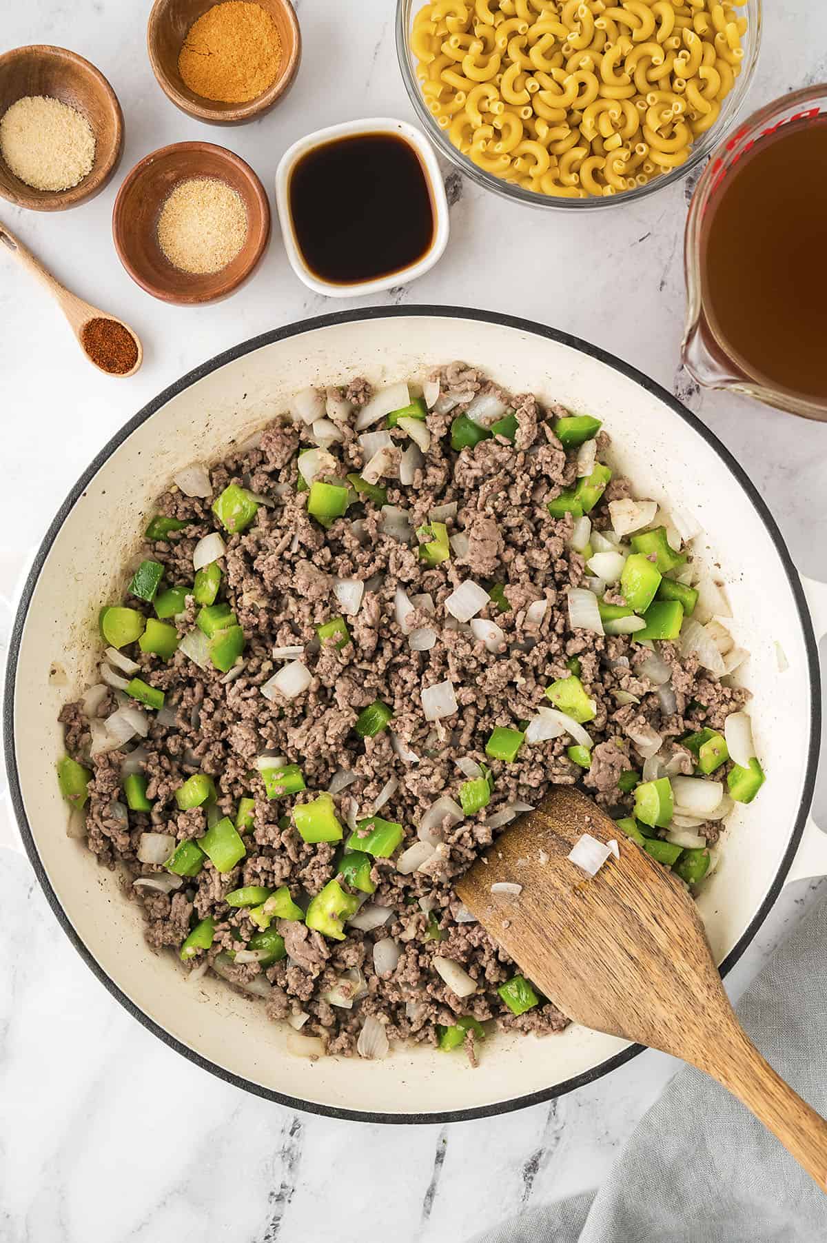 Onions and pepper in skillet with beef.