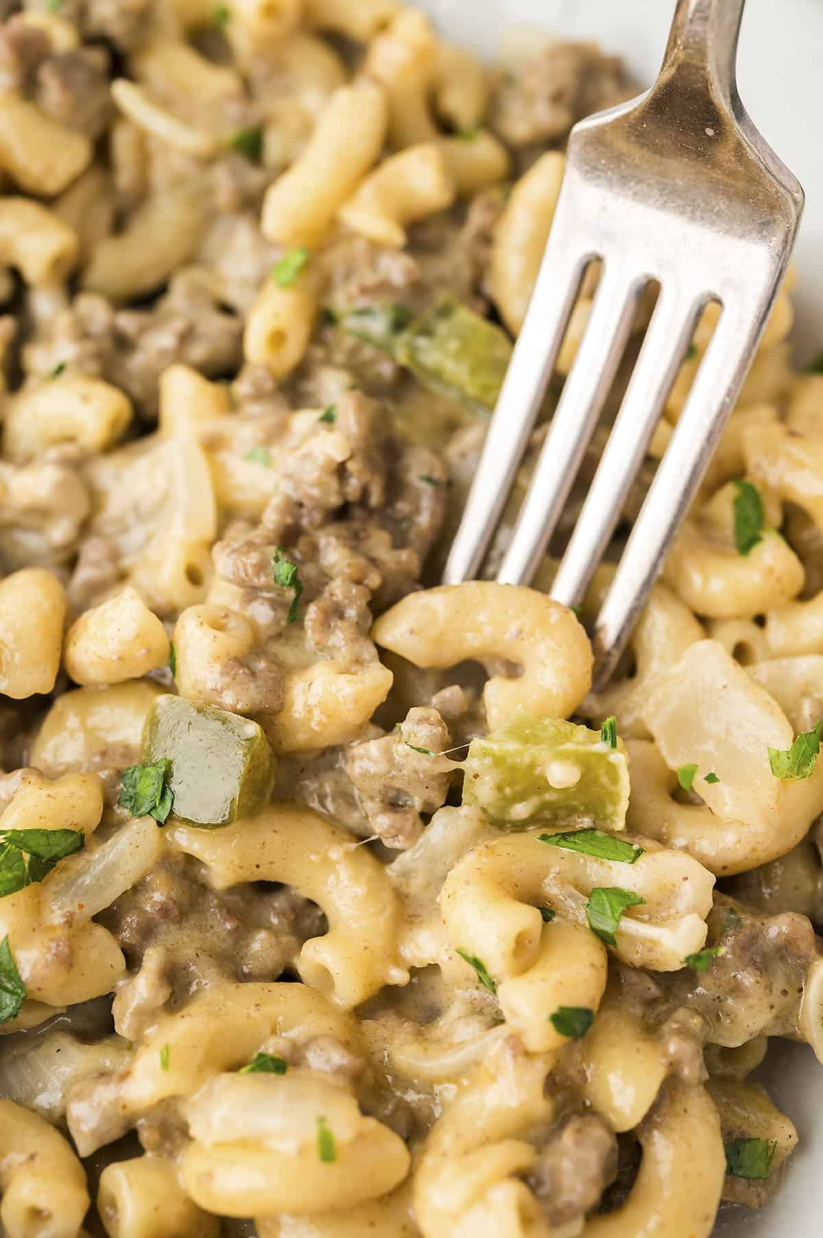 Fork in bowl of Philly steak pasta recipe.