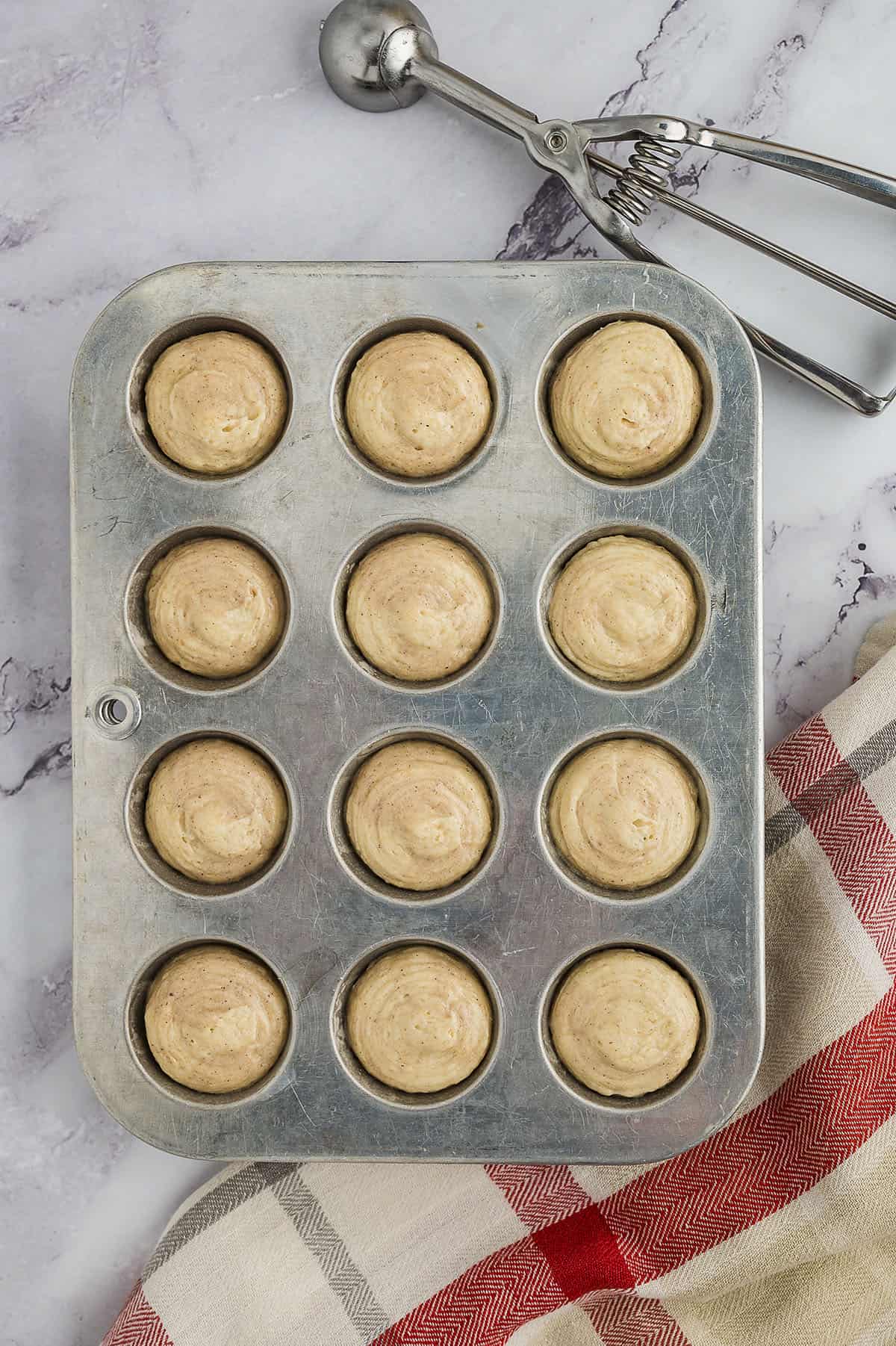 Muffin batter in mini muffin tin.