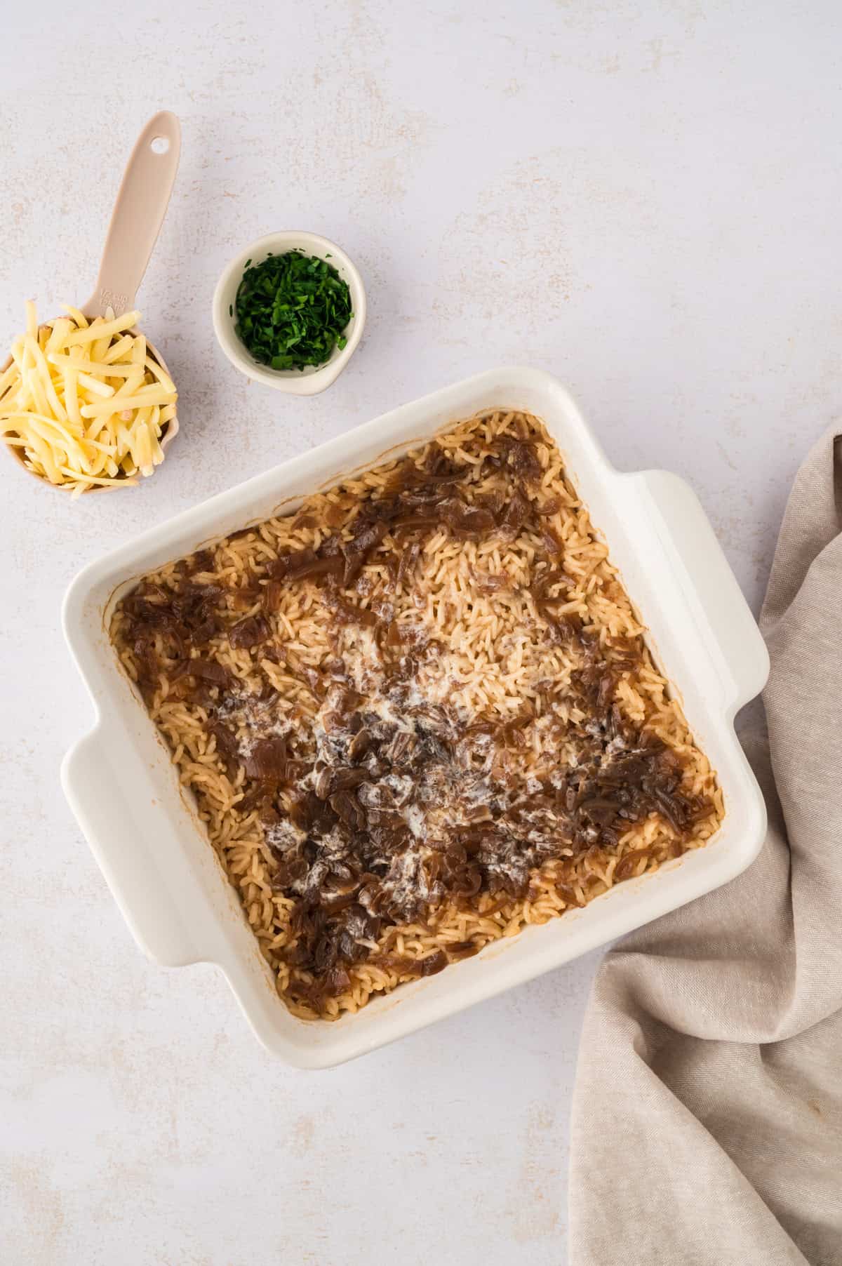 Baked french onion soup rice in white dish.