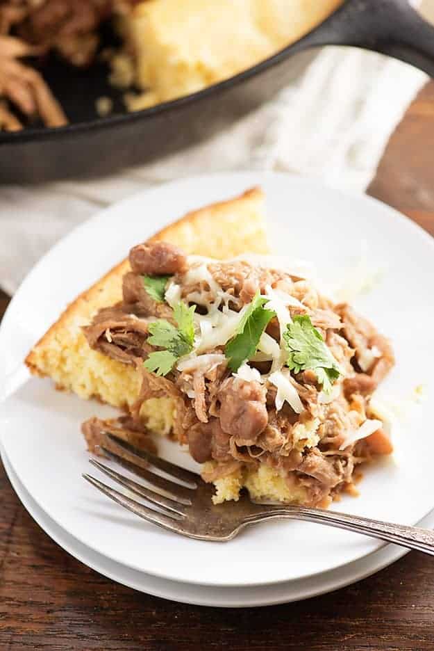 Slow cooker pork and beans! This is a cheap and easy slow cooker dinner that's perfect over cornbread. We love this for Mexican night! 