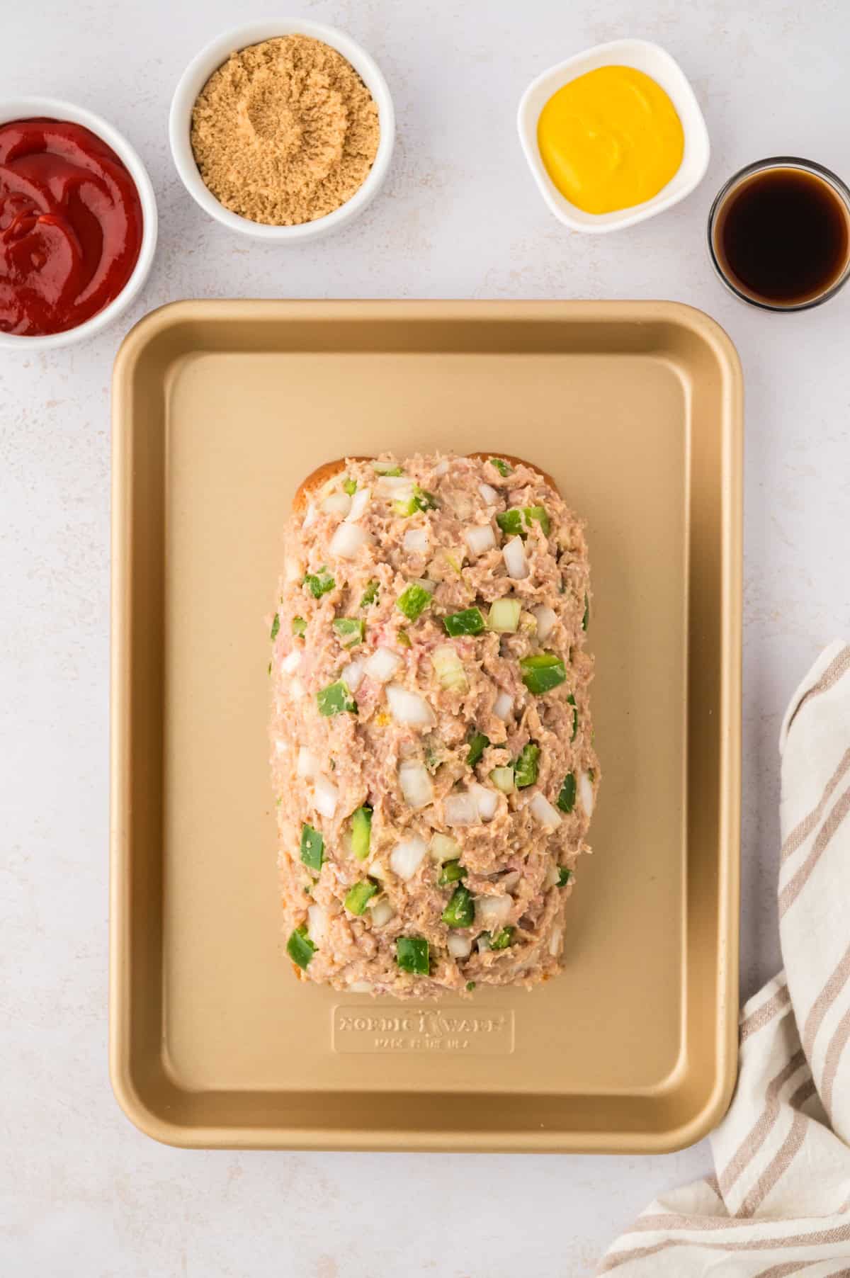 Turkey meatloaf shaped on sheet pan.