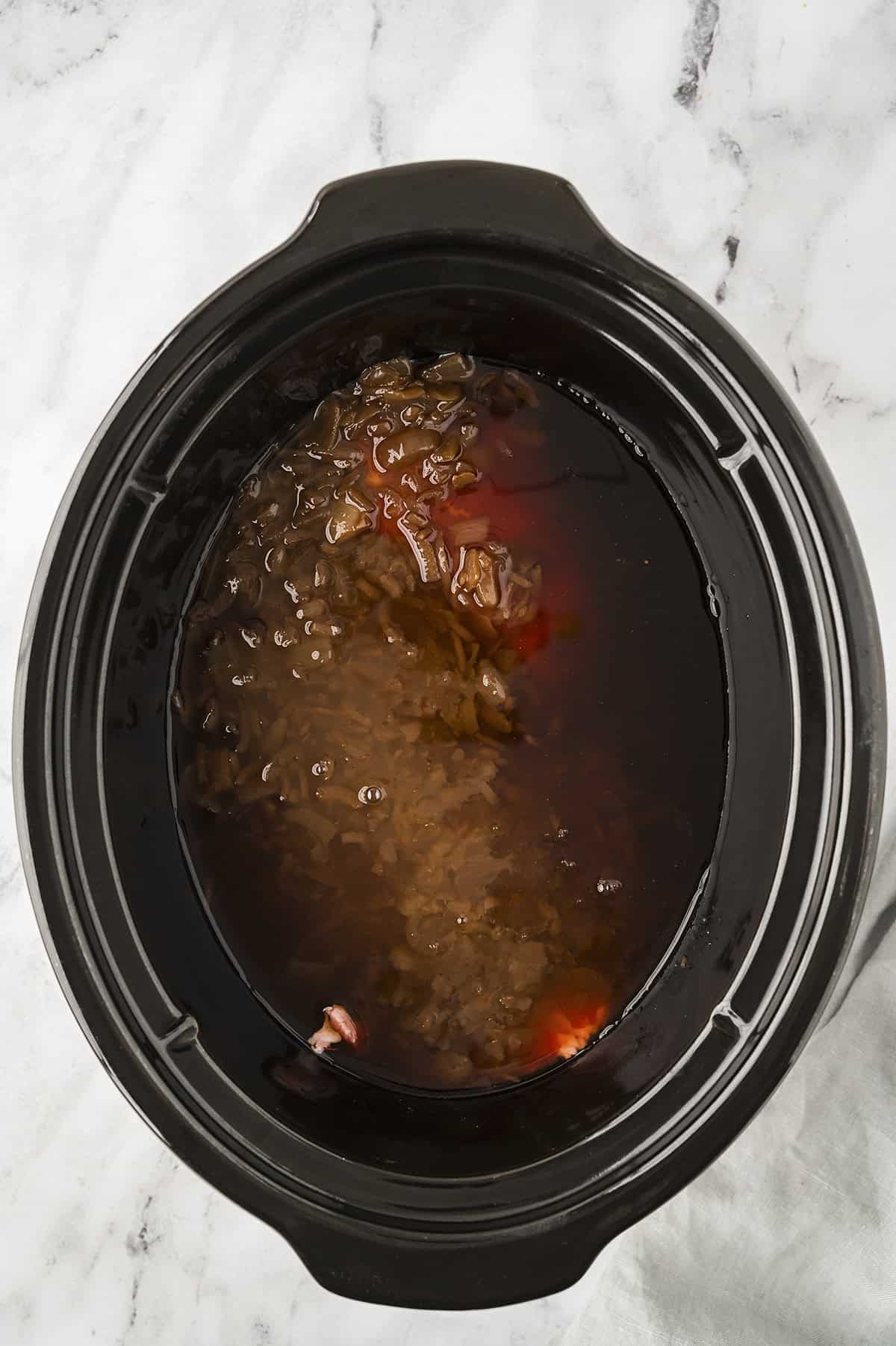 Chuck roast and broth in slow cooker.