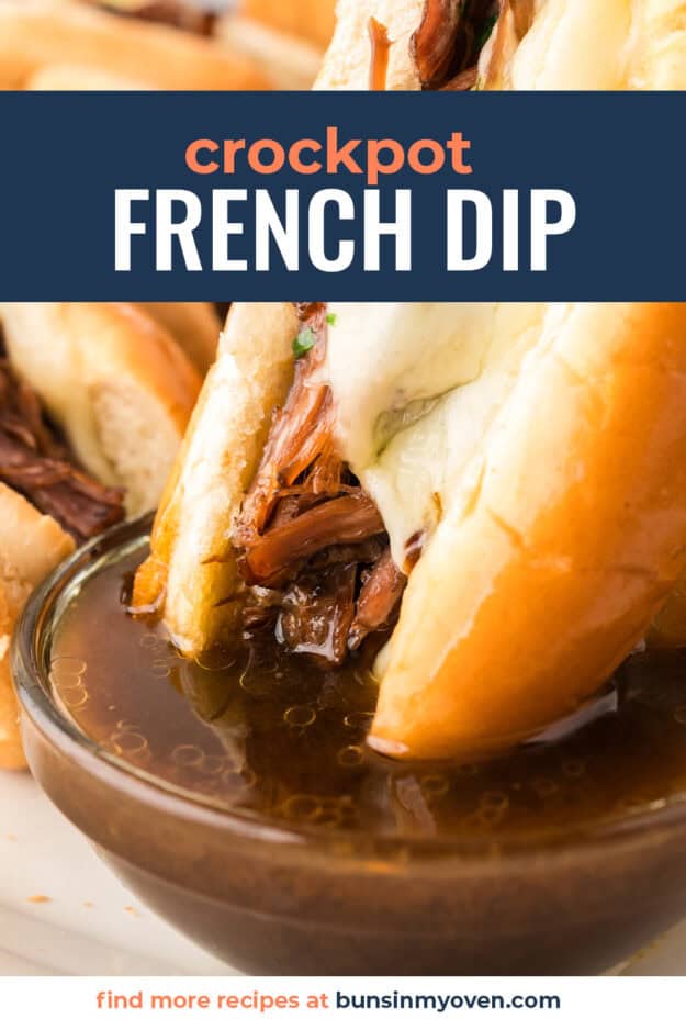 French dip sandwich being dunked in au jus.