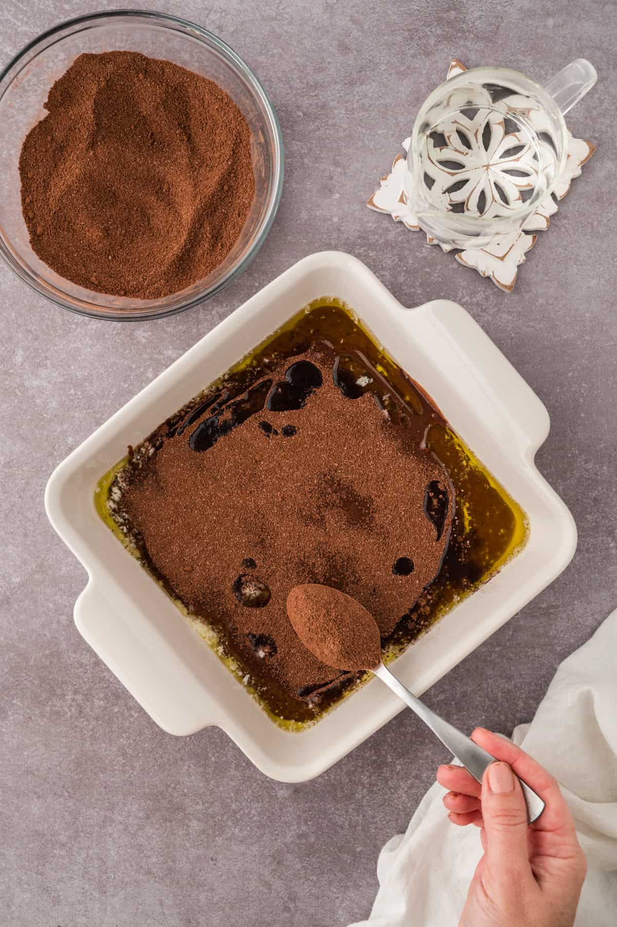 Topping for chocolate cobbler being spooned over the filling.